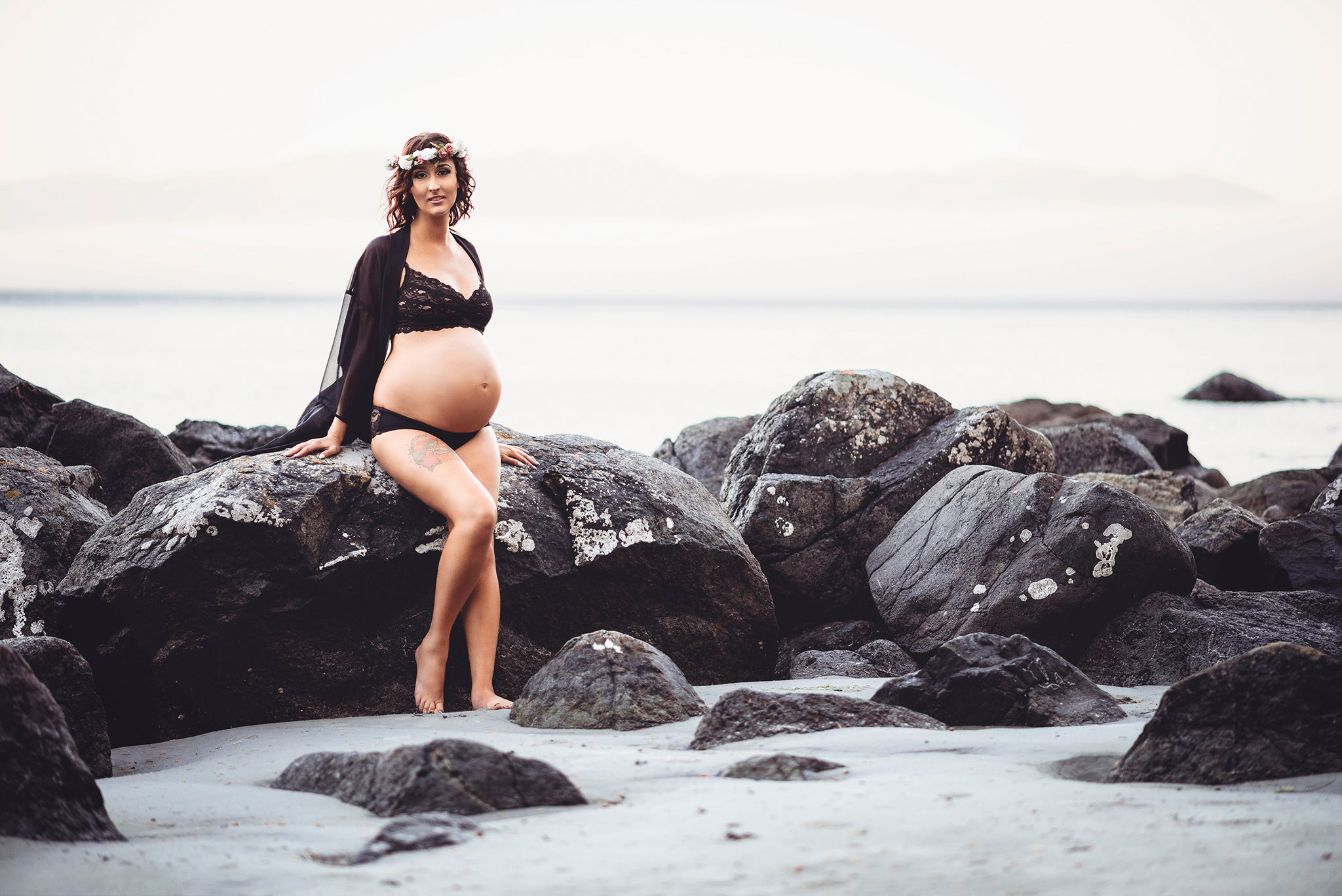 Maternity photography in black lingerie and flower crown at East Sooke Park beach near Victoria.