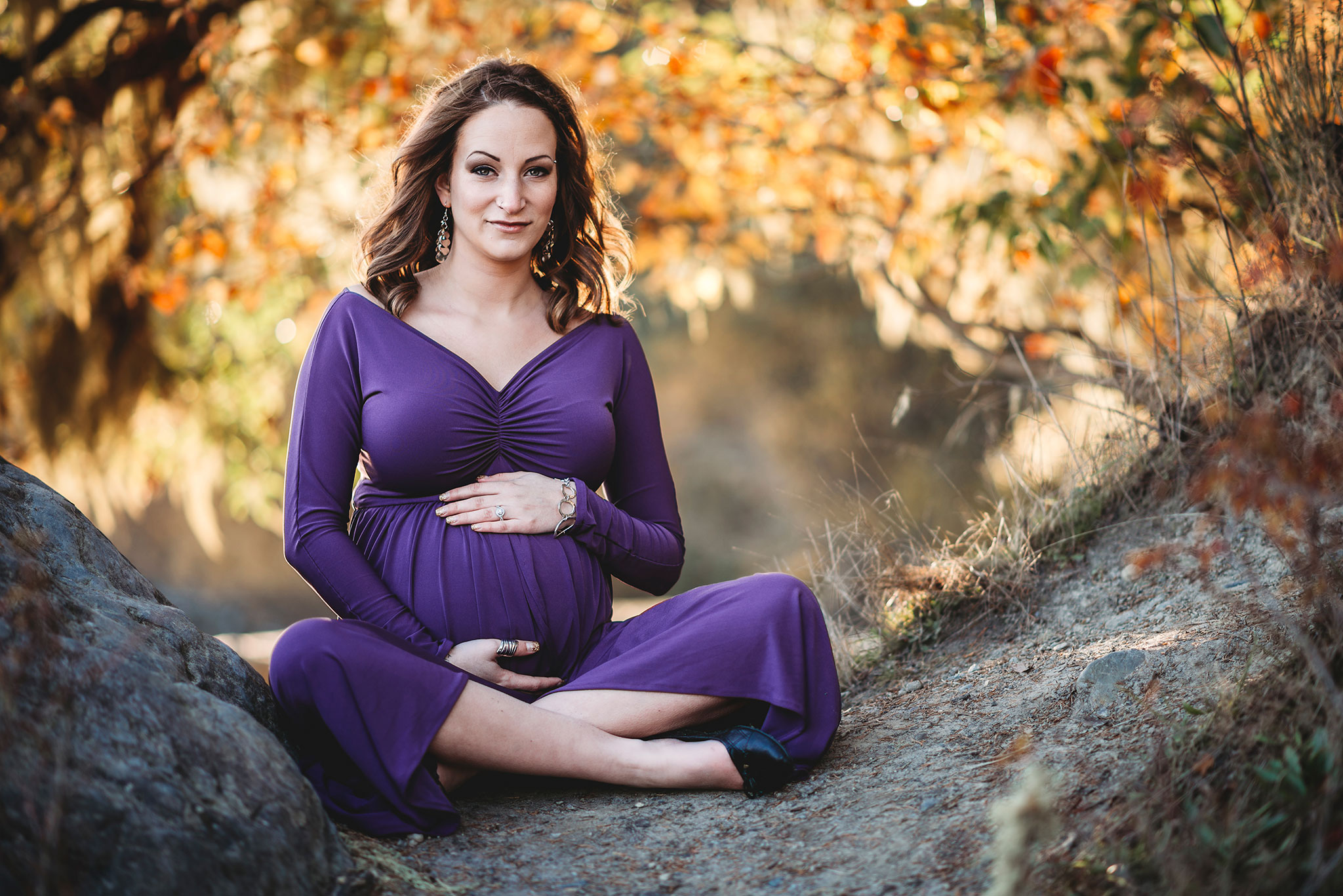 Fall maternity photography in a purple maternity gown at sunset in East Sooke Park near Victoria.