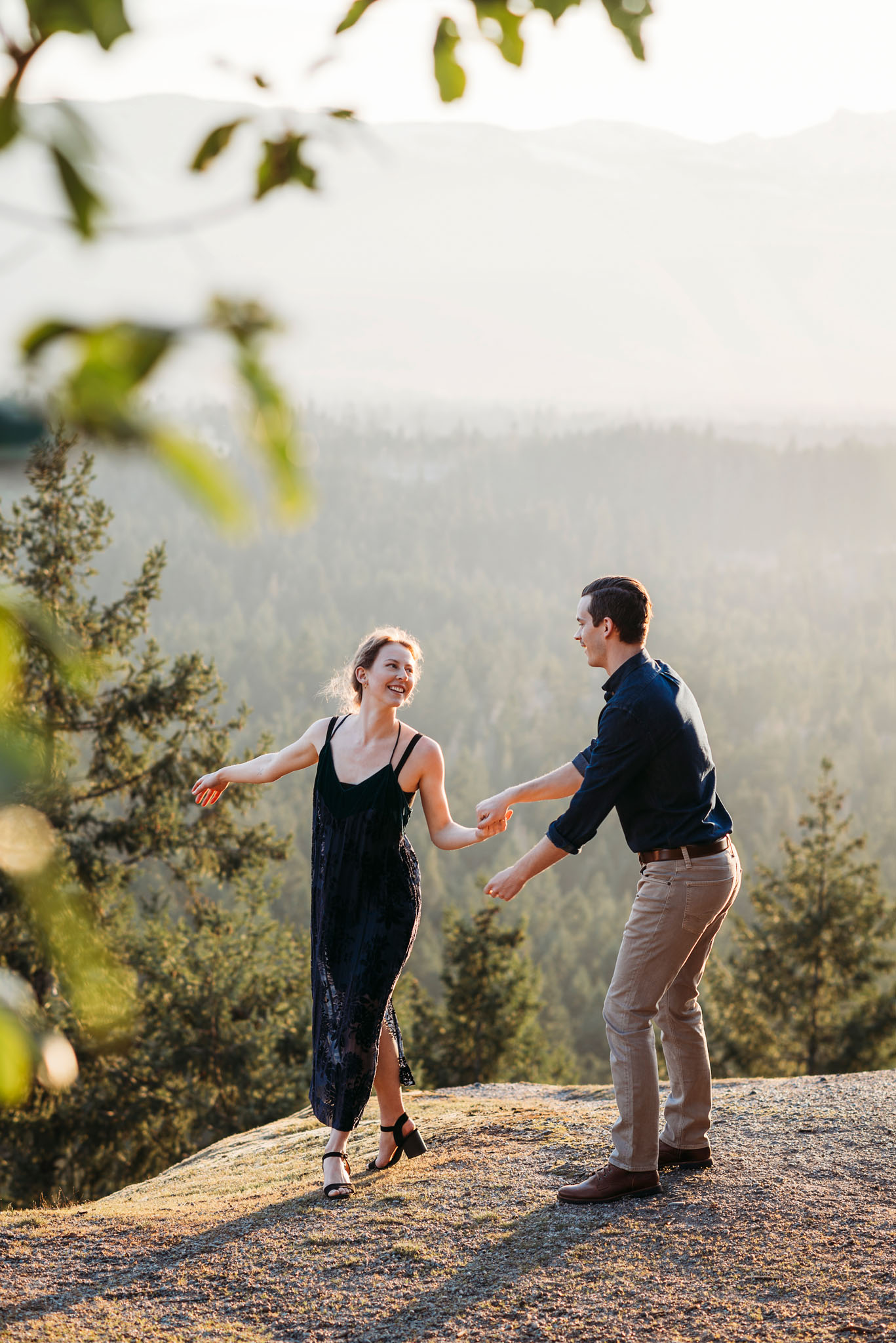 Couple dancing on a Parksville, BC mountaintop at sunset.